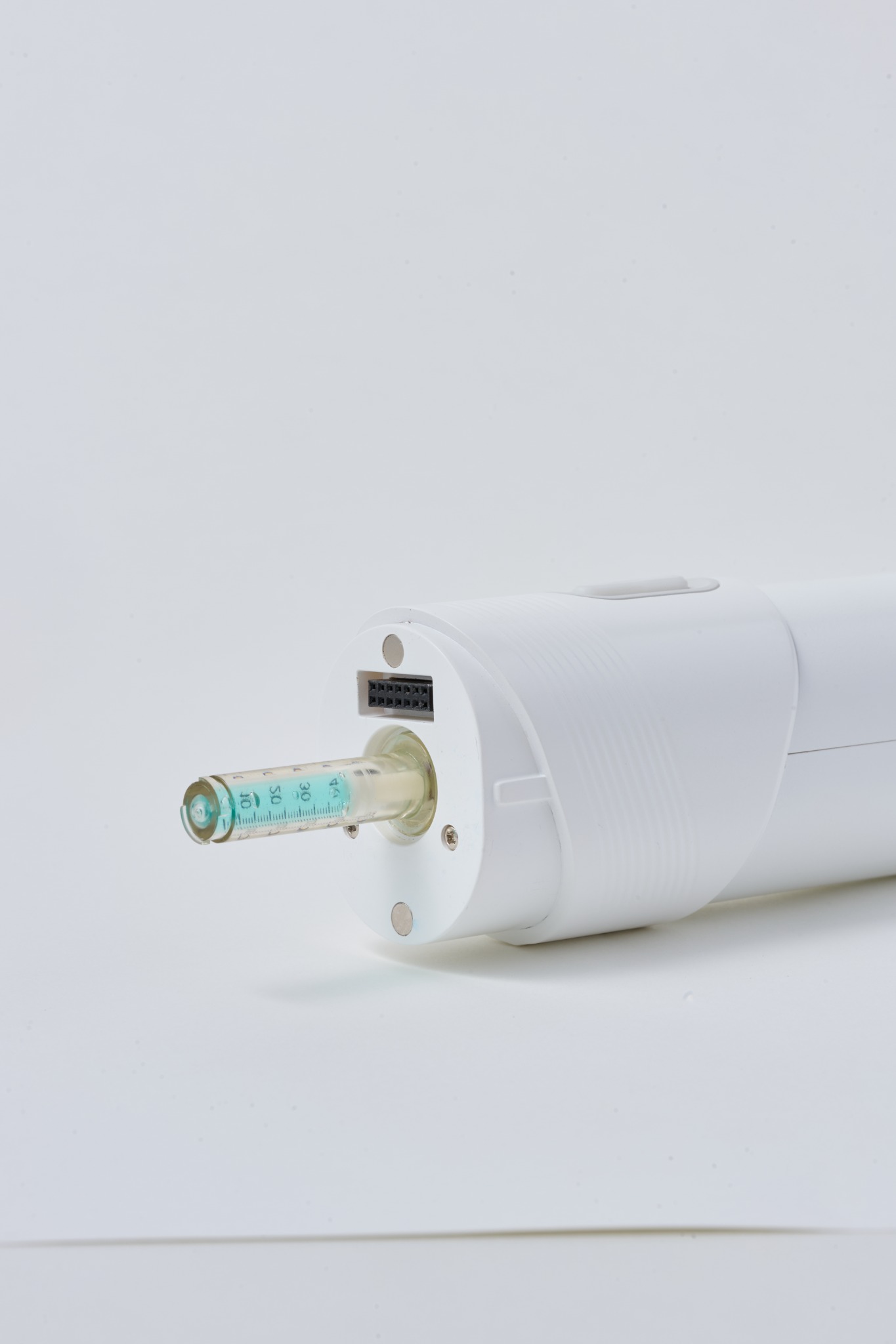 Close-up of the Quick-Trans ampoule interface on the AET-Shot handpiece